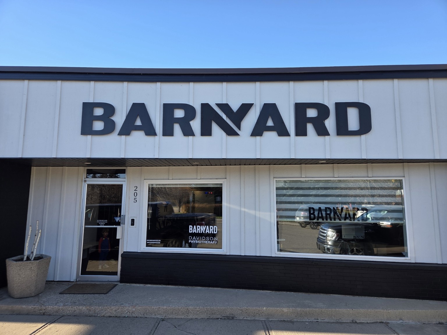 Black dimensional BARNYARD lettering installed on the white exterior of a commercial building