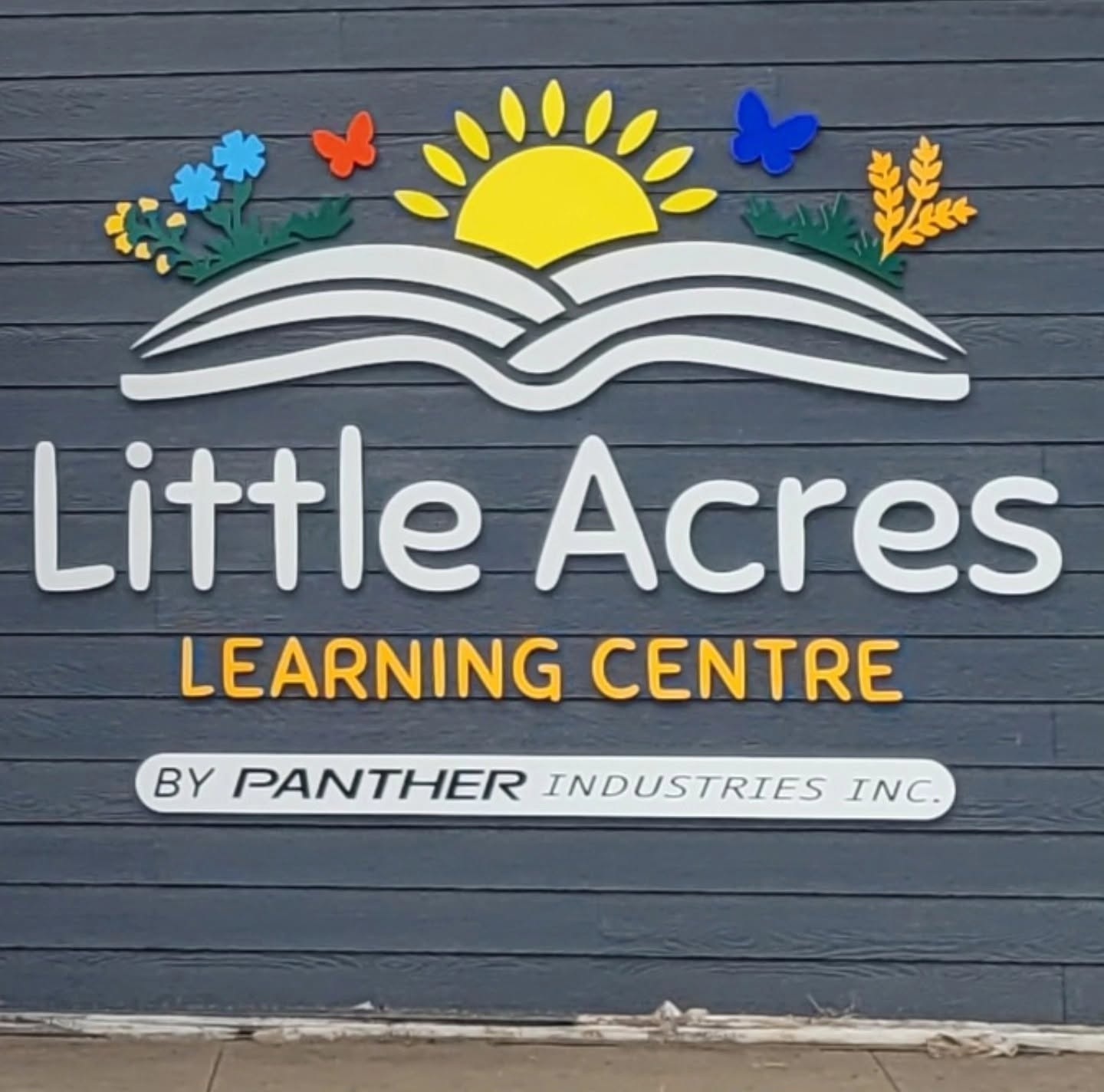 Dimensional Little Acres Learning Centre letters and colourful graphics mounted on a building