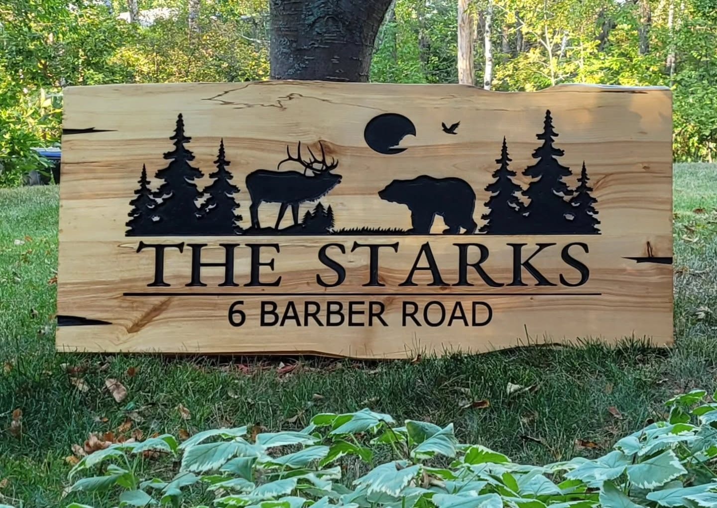 Wood cabin sign with wildlife silhouettes and personalized lettering