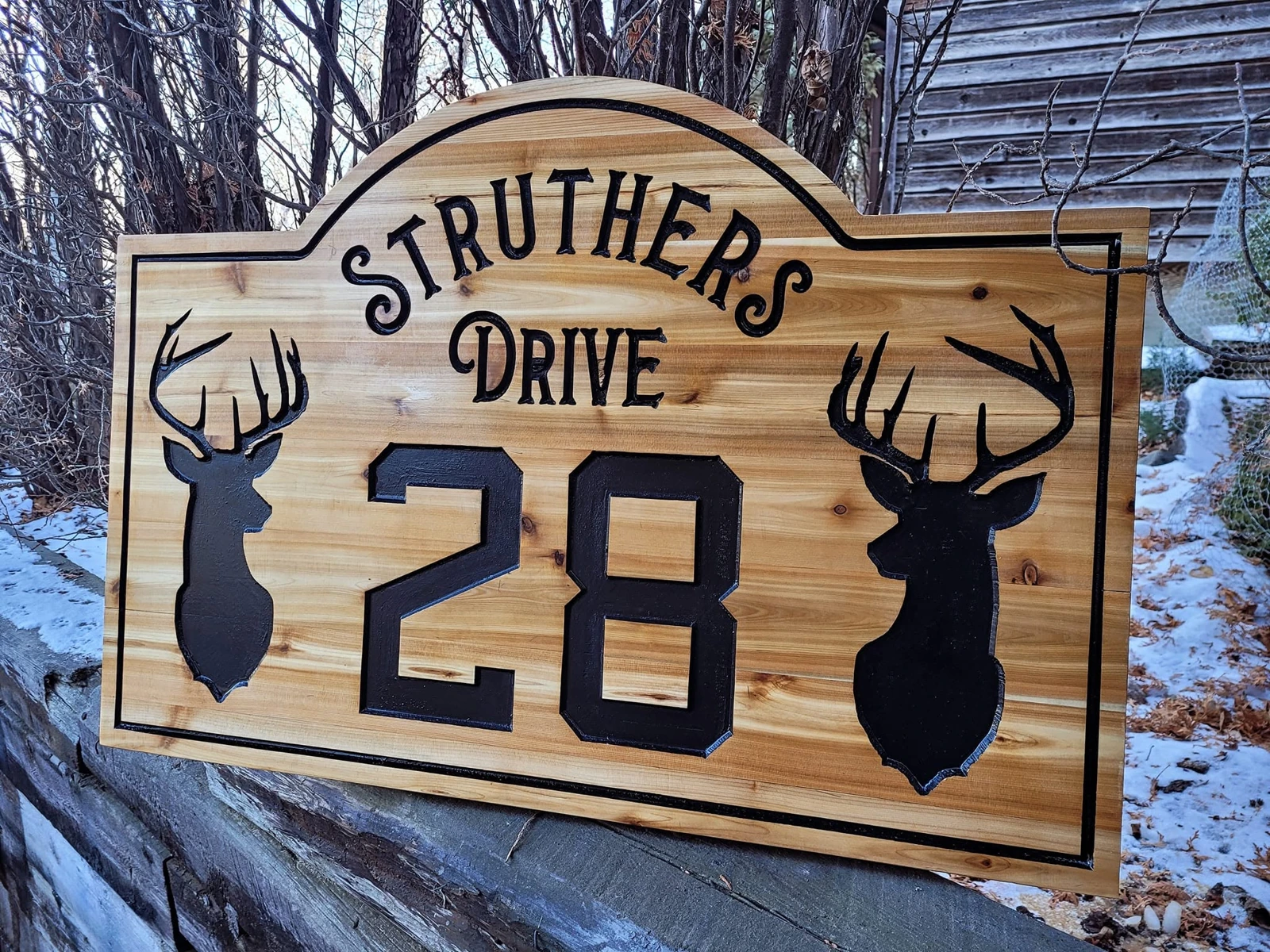 Wood cottage sign with deer silhouettes and address number 28