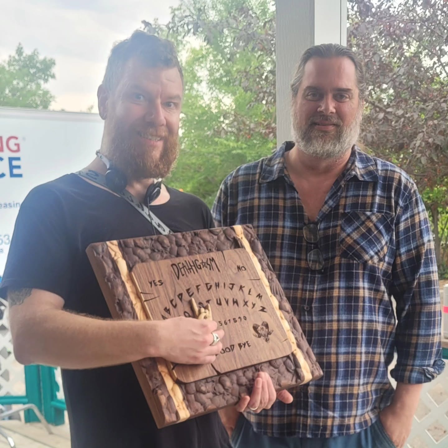 Movie director and maker holding the custom carved wooden movie prop