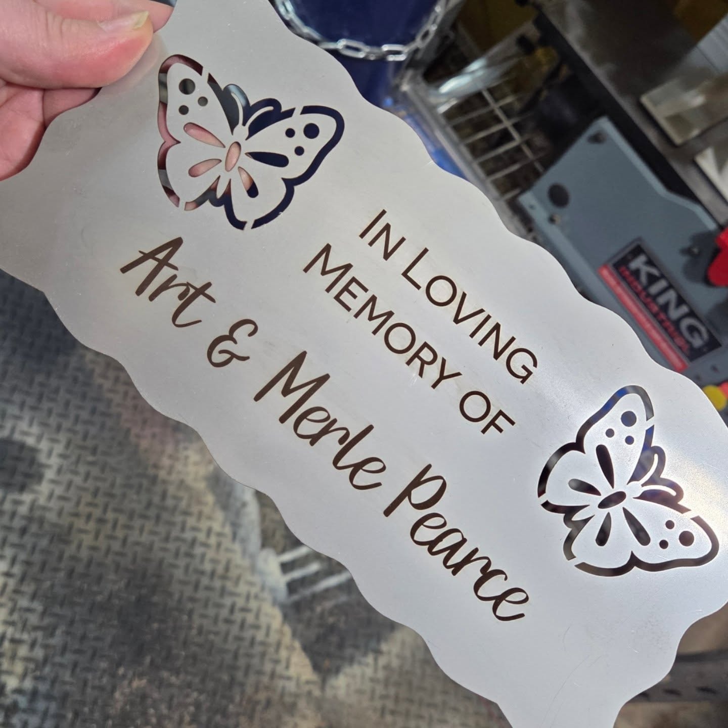 Stainless steel memorial bench plaque with butterfly cutouts and personalized lettering
