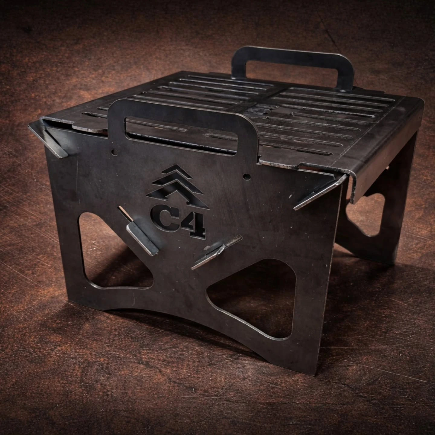 Compact steel fire pit with grill and cutout details